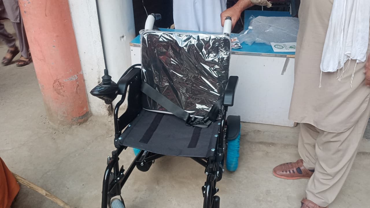 The recipient trying out the electric wheelchair donated by the Foundation.