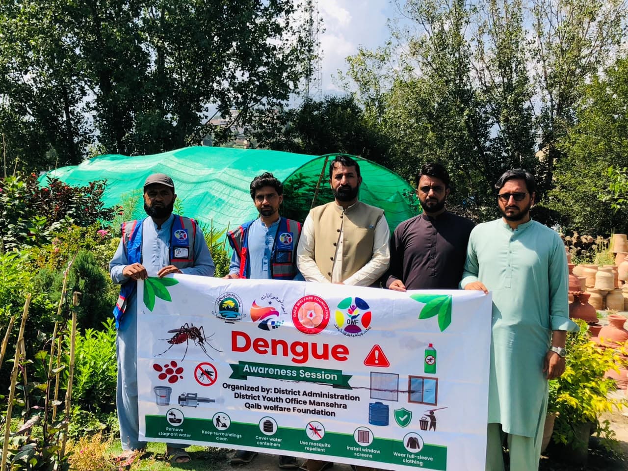 The OWF team briefing Oghi shopkeepers on dengue prevention and safe practices.