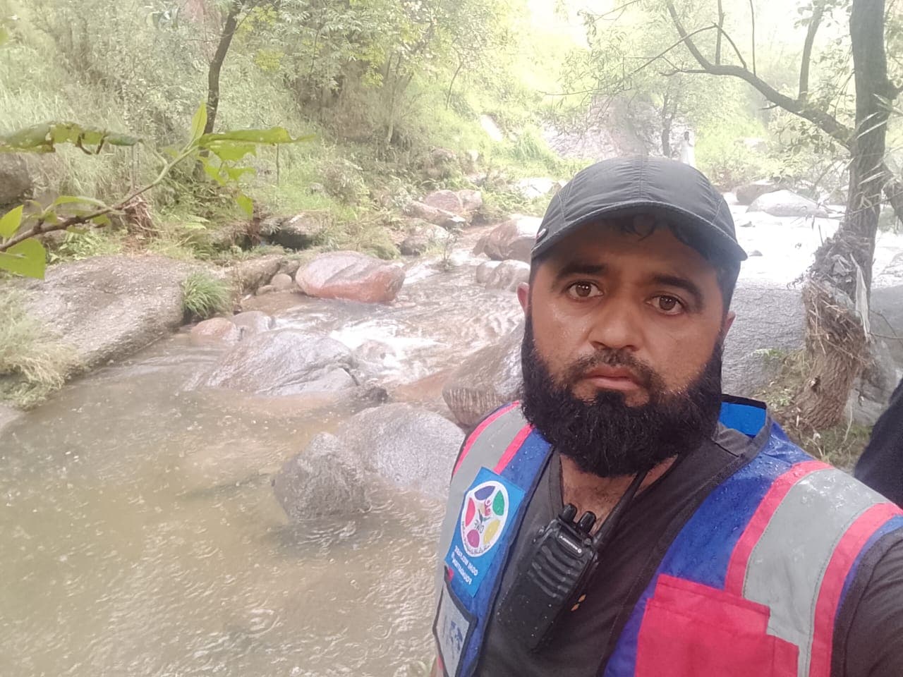OWF volunteers searching for a person swept away by floodwaters, alongside the local community.