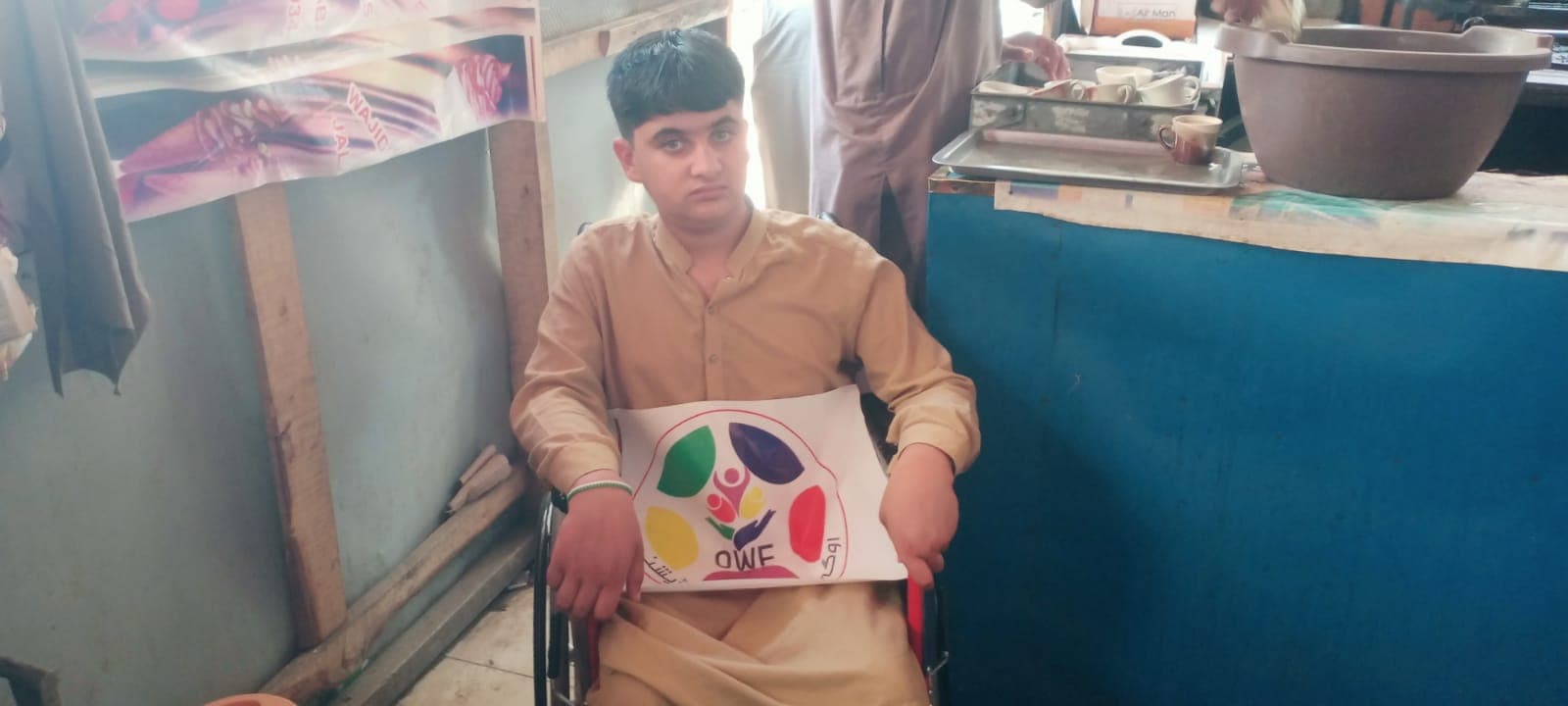 A wheelchair handed over to a deserving 16-year-old boy so he can move on his own again.