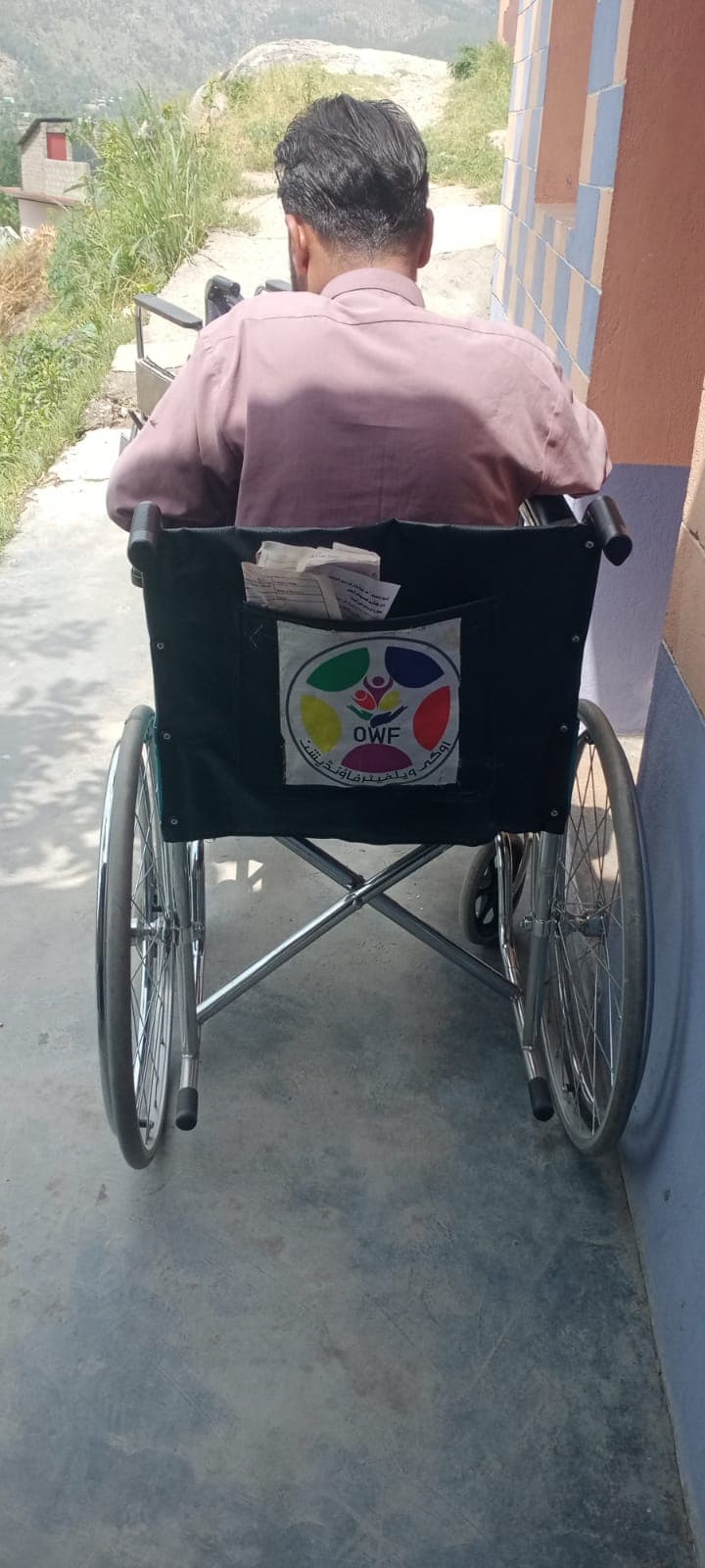 A wheelchair handed over to a deserving person with a disability in the Oghi area.